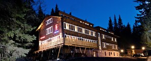 A multi-story building with a reception area, wooden facade, and multiple windows. - Eko sport hotel Björnson (Demanovska Dolina)