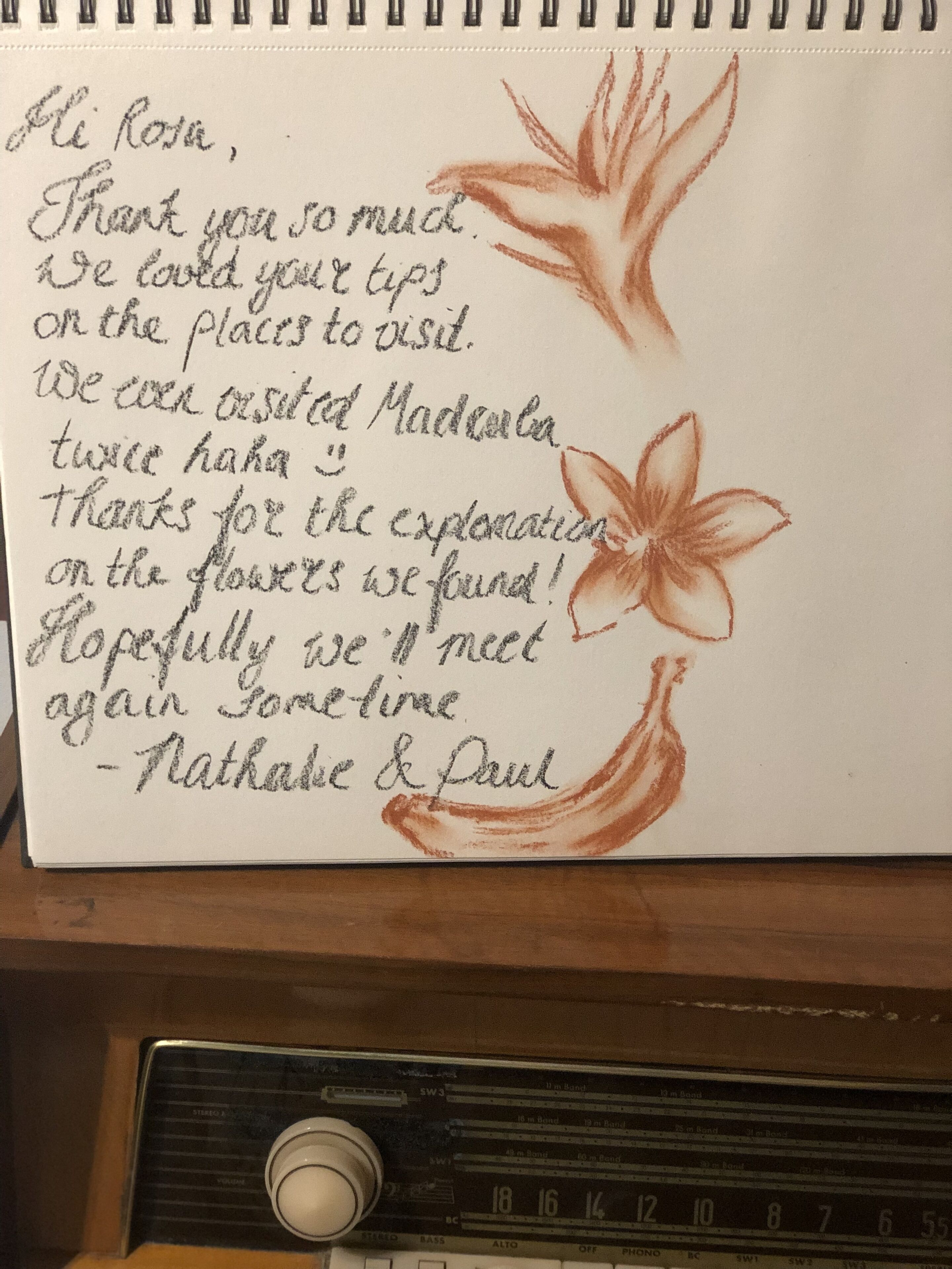 A handwritten note with flower illustrations, expressing gratitude and mentioning a visit to Madeira.