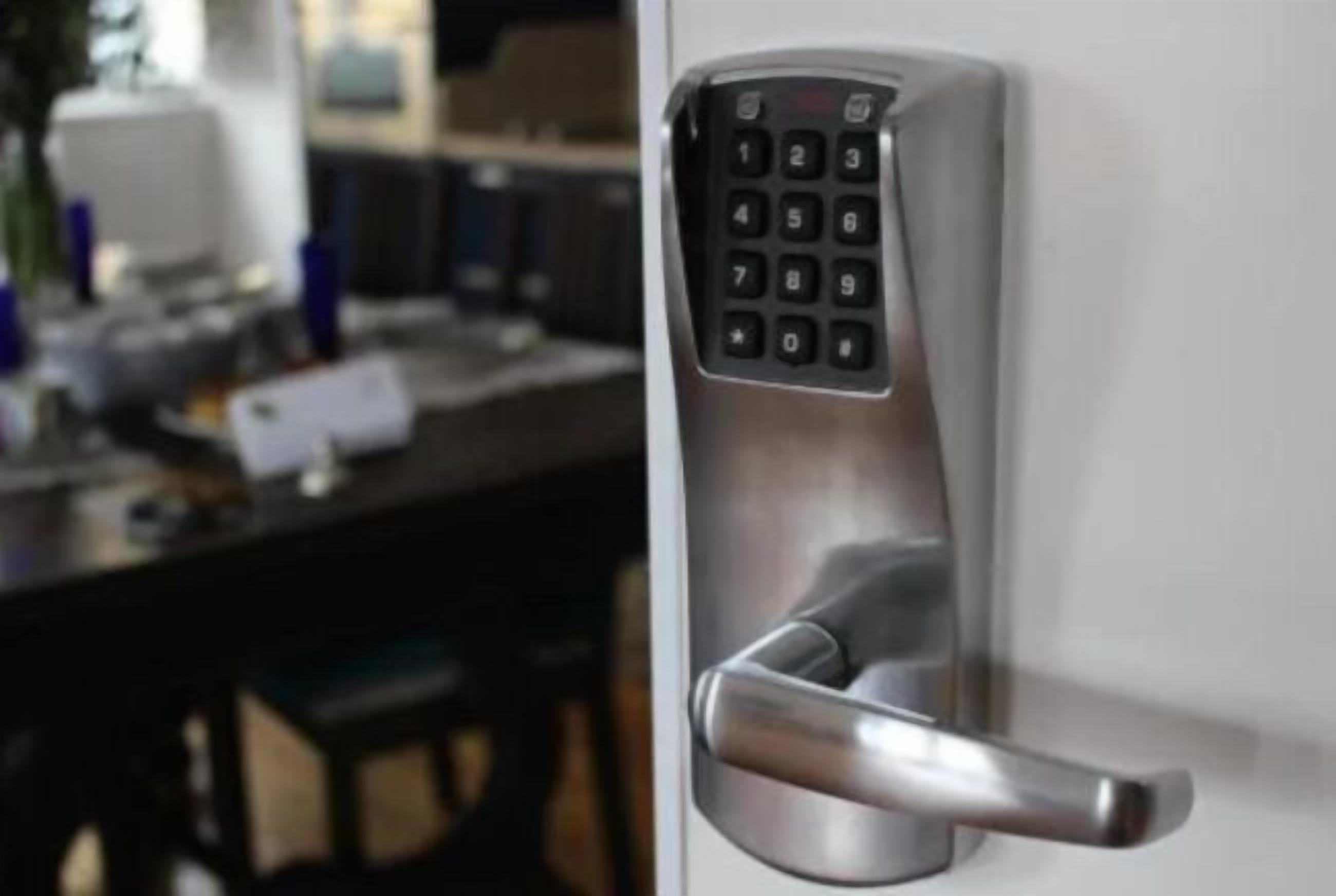 A modern door with a numeric keypad lock.