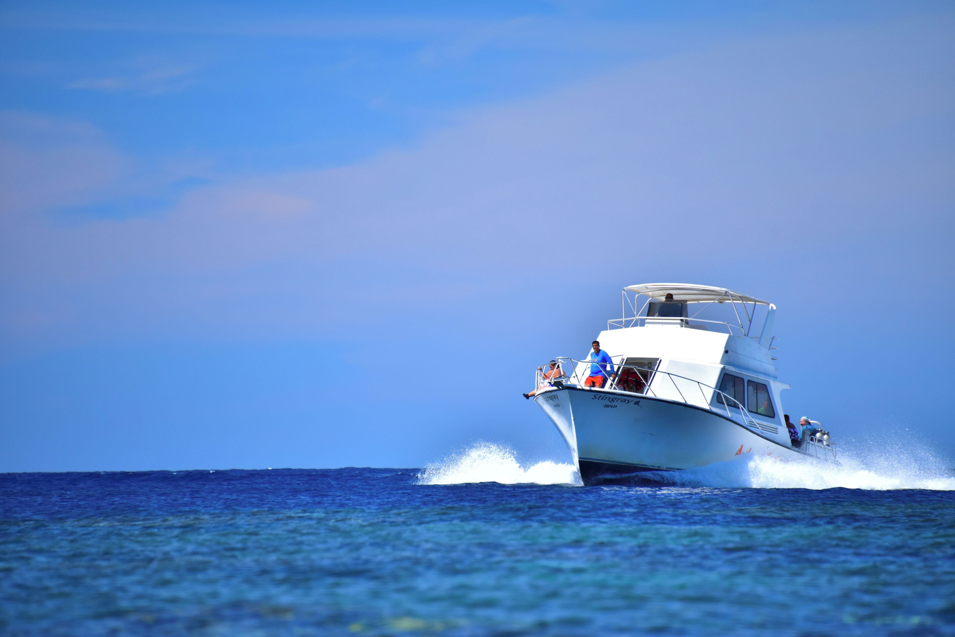 A boat with passengers, moving through the water.