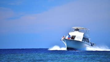 A boat with passengers, moving through the water.