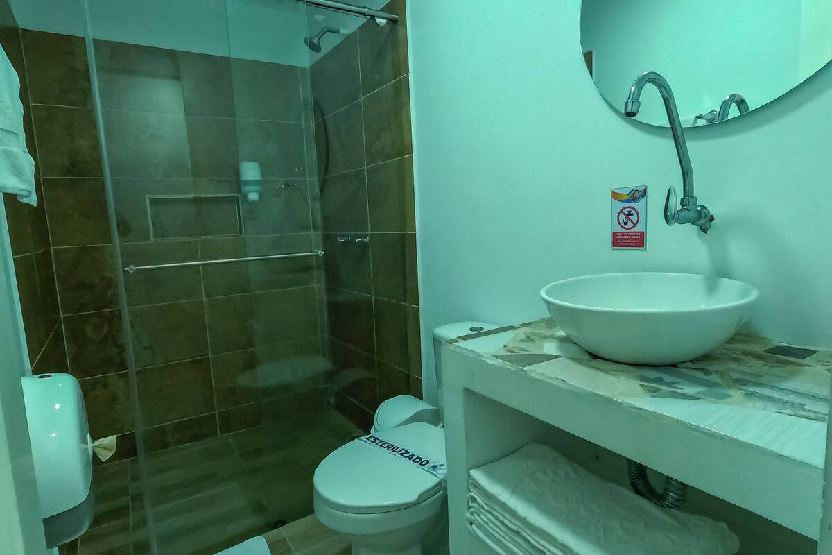 standard room, multiple beds | bathroom | shower, rainfall showerhead, towels