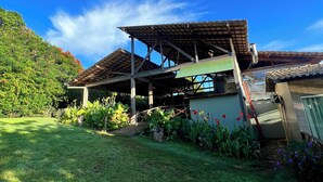 A house with a garden and a covered outdoor area.