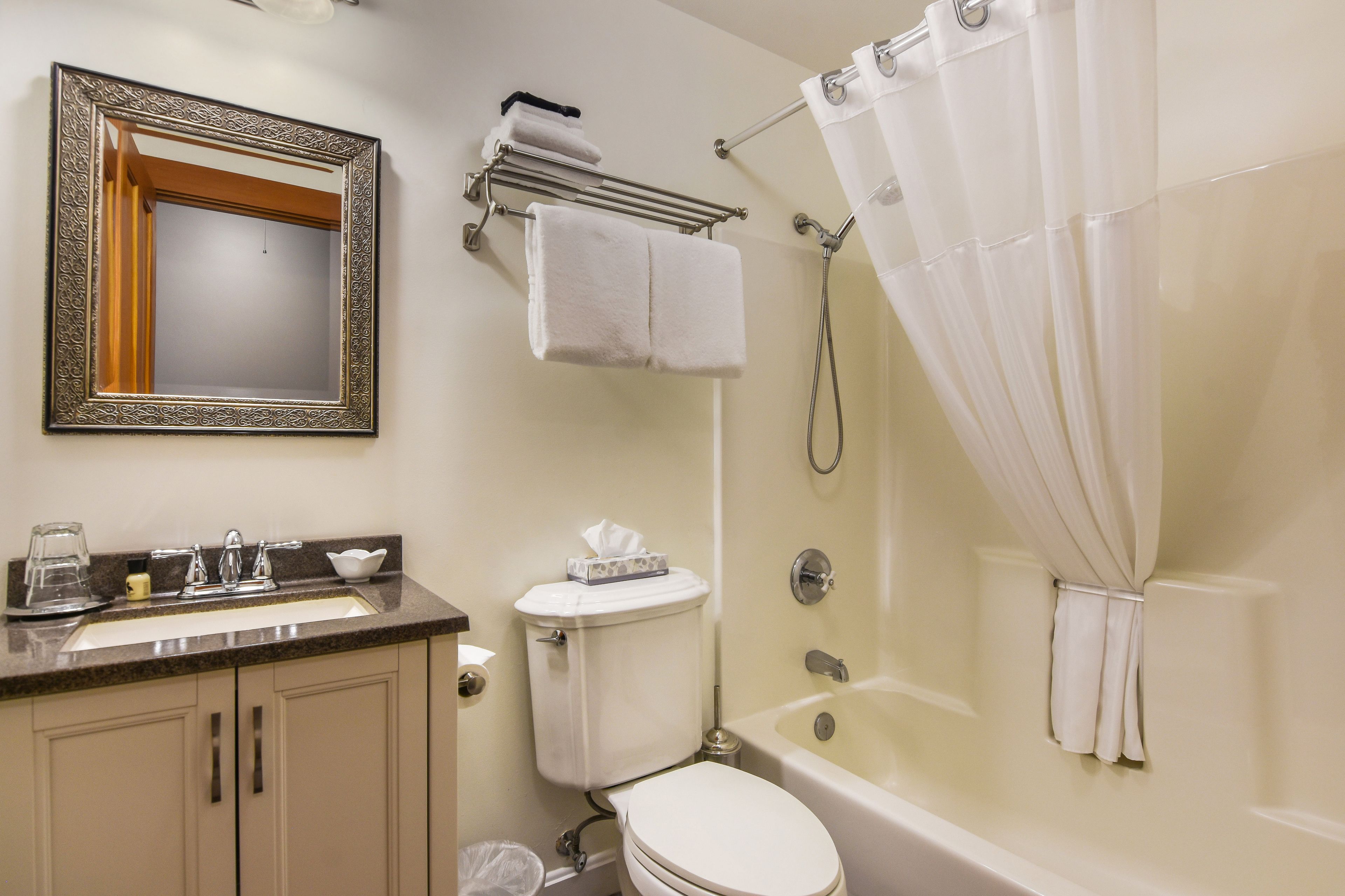 A bathroom with a sink, toilet, and bathtub.