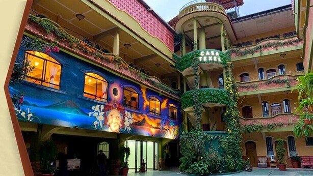 A multi-story building with balconies, a central atrium, and a sign reading "Casa Texel". - Hotel y Restaurante Casa Texel (Panajachel)