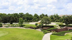 A golf course with well-manicured lawns, a variety of trees, and a clear sky. - RVH 121 Centre Court Dream (Kissimmee)