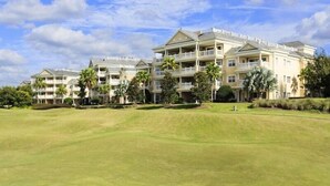 A large, multi-story hotel with a well-maintained lawn in front. - RVH 121 Centre Court Dream (Kissimmee)