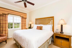 A hotel room with a large bed, two bedside tables with lamps, a wooden headboard, and a window with curtains. - RVH 052 Relax in Centre Court (Kissimmee)