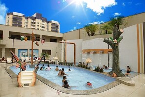 An indoor swimming pool with multiple water features, including a waterfall and a tree-shaped structure. - Prive Thermas Hotel by WAM Experience (Caldas Novas)