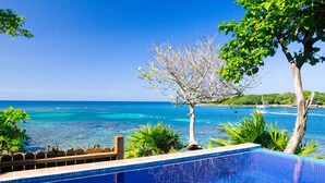 A clear blue sky, a swimming pool, and a view of the ocean. - Coral Vista 1 2 bedroom option (Roatan)