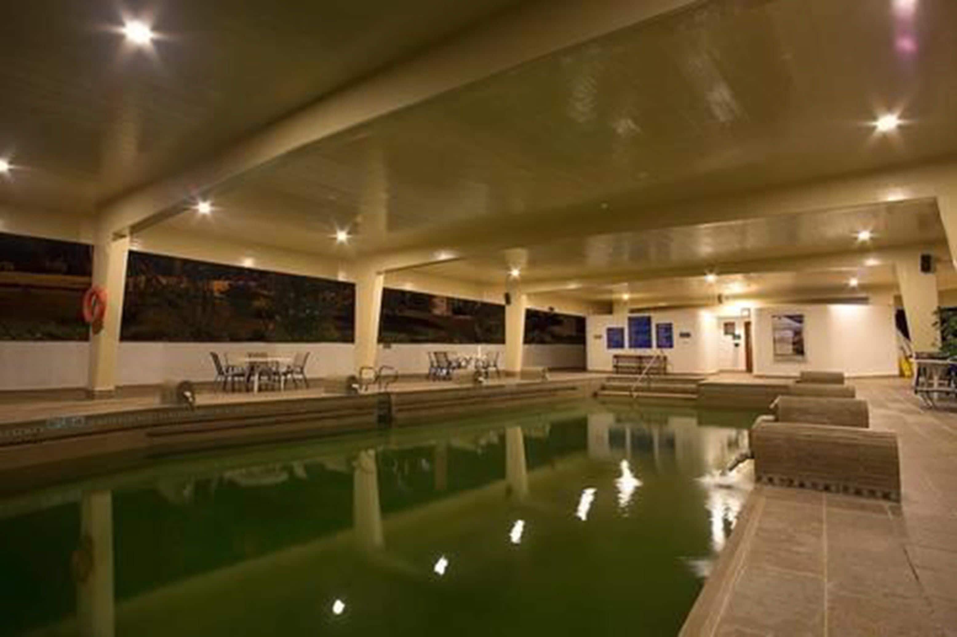indoor pool, open 7:00 am to 10:00 pm, pool umbrellas, pool loungers