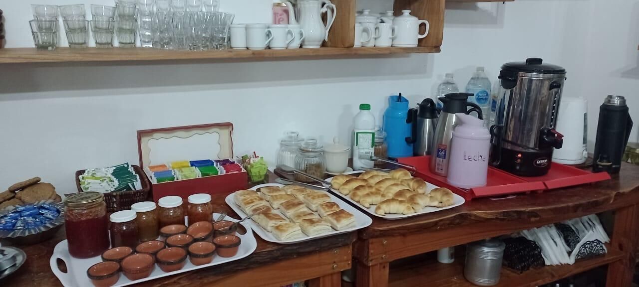 A kitchen counter with various food items, utensils, and kitchen appliances.