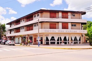 A two-story building with a sign reading "HOTEL DON CARLOS." - Don Carlos Hotel (Villa Gesell)