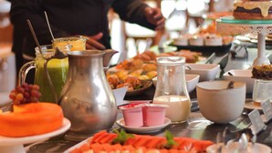 Un bufé con diversos alimentos y una jarra de leche.