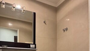 A modern bathroom with a glass sink, bidet, and toilet.