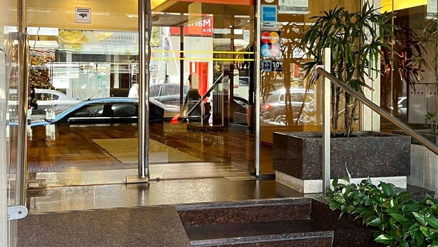 A hotel entrance with glass doors, a staircase, and a sign indicating the hotel name. - Hotel Torre (Buenos Aires)