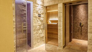 A hotel elevator with a stone wall and a wooden door. - Alpemar Apart Hotel & Spa Villa Gesell (Villa Gesell)