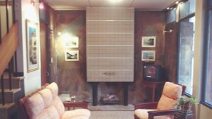 A cozy living room with two armchairs, a coffee table, and a fireplace. - Hotel Dali (San Rafael)