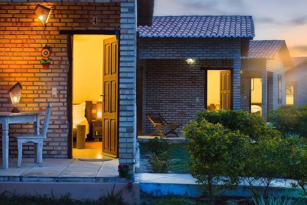A two-story house with a brick exterior and a tiled roof.