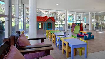 Children can play and explore in this well-designed play area with tables, benches, and a view of the adjacent playground.