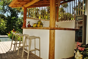 Piscina a l'aire lliure, piscina amb cascada, para-sols i gandules