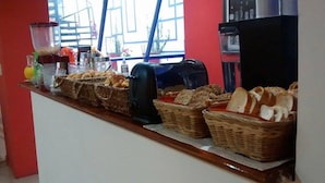 A breakfast buffet with various breads and pastries, a coffee machine, and a blender. - Altea Hotel de Rosario (Rosario)