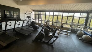 Ein Fitnessraum mit Laufbändern, Crosstrainern und Kraftgeräten.