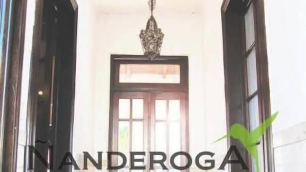 A hallway with a double door, a hanging light fixture, and a tiled floor. - Ñanderoga (Corrientes)