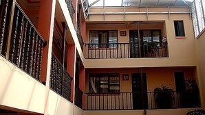A multi-level building with balconies and a glass ceiling. - Hostal Santa Teresa de Jesús (Sucre)