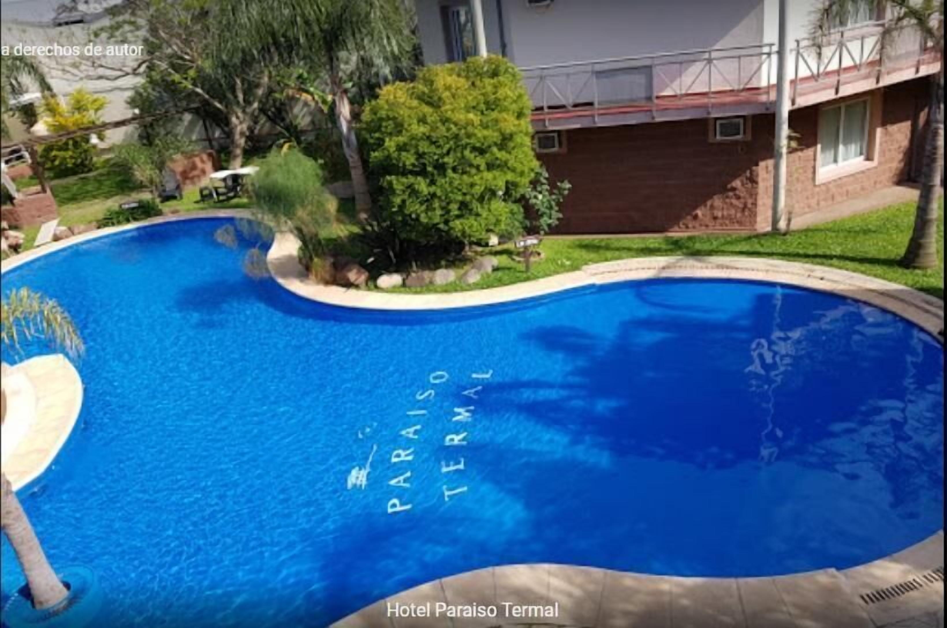 A swimming pool with the words "PARAISO TERMINAL" written on the water.