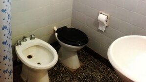 A small bathroom with a bidet, toilet, and sink. - Hosteria La Cabaña (Puerto Iguazú)