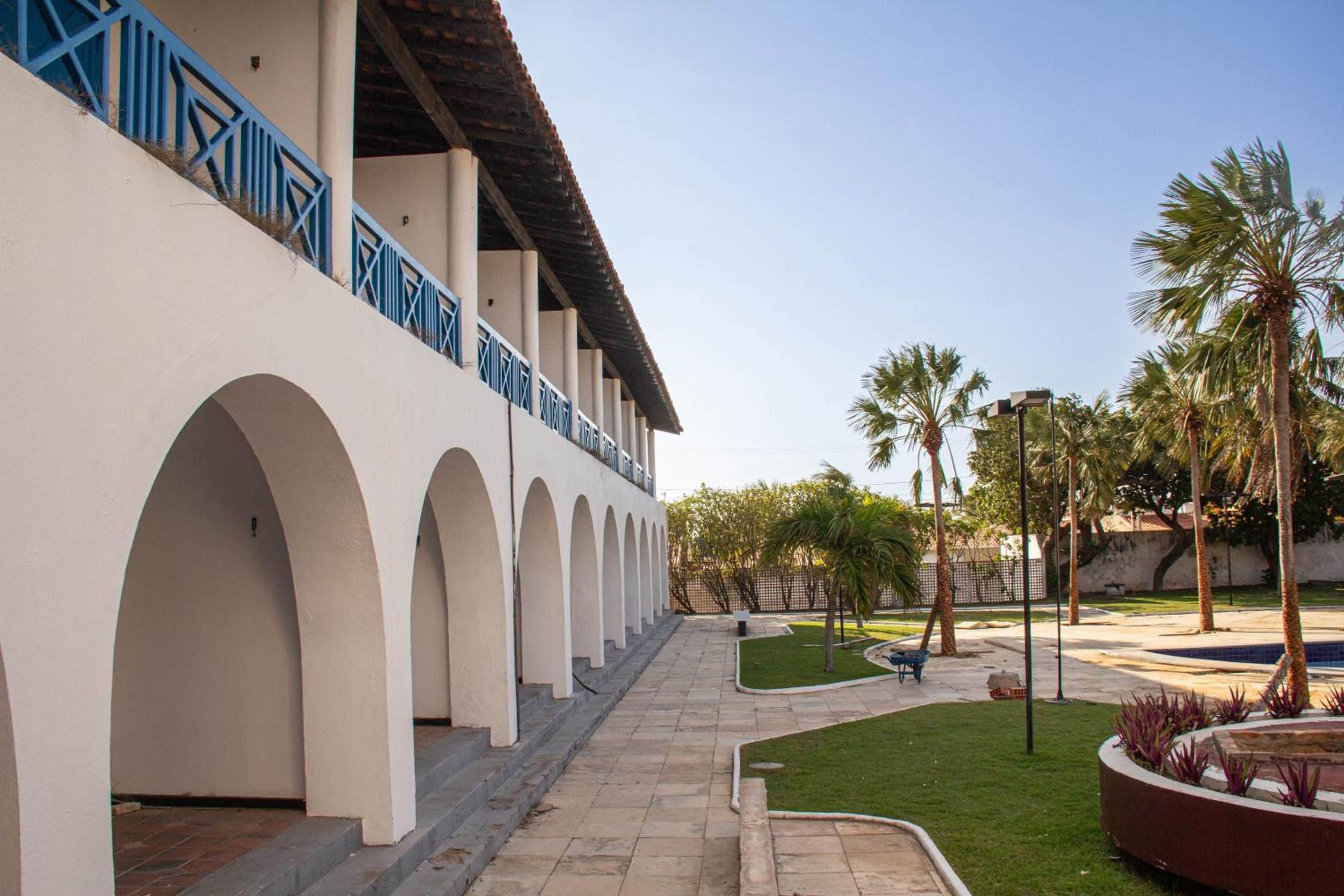 A building with a series of arches and a covered walkway.