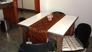 Una sala de conferencias con una mesa, sillas, un extintor y un televisor en la pared.