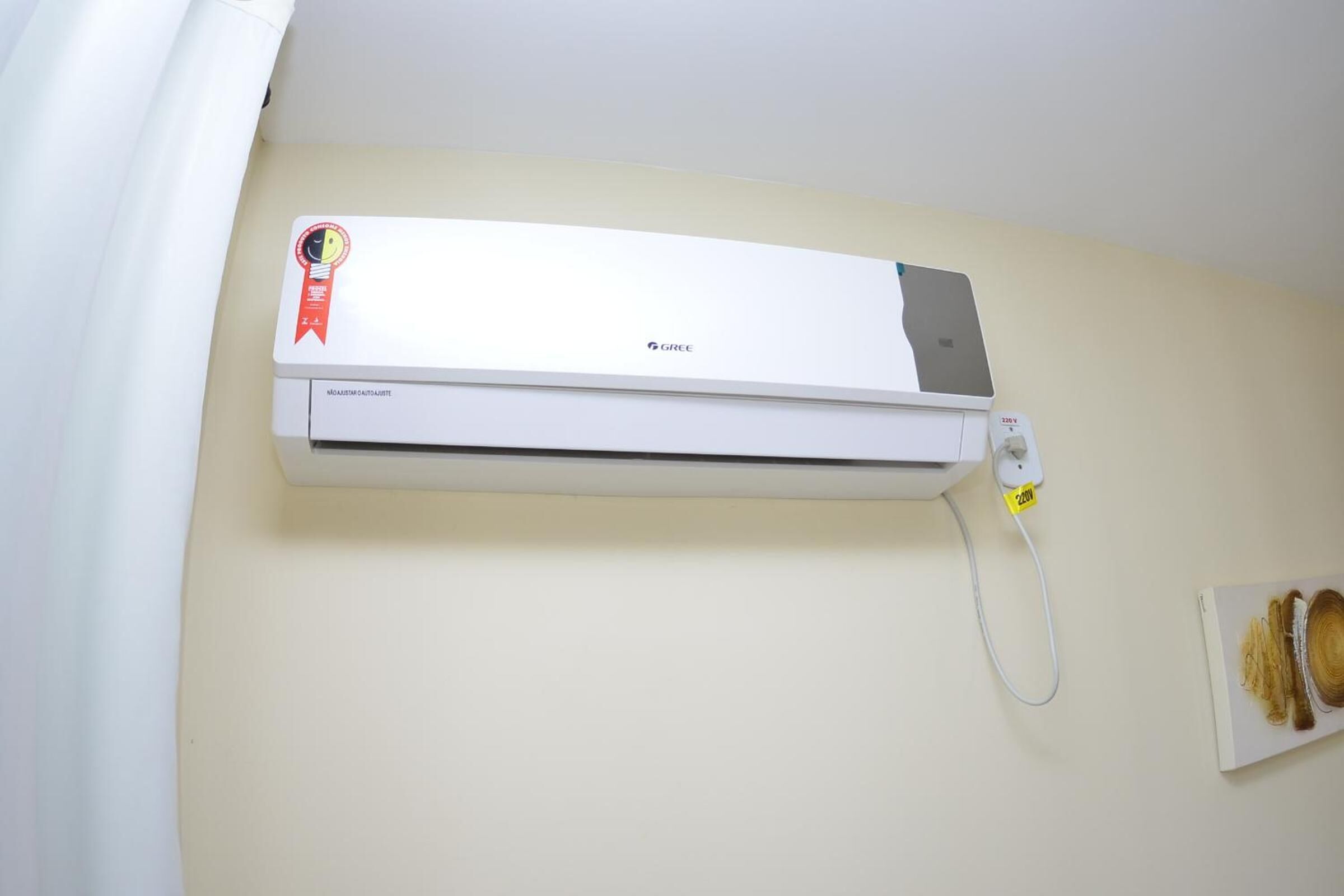 A wall-mounted air conditioning unit with a visible brand logo and a certification badge.