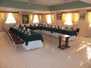 Conference room with a long table and comfortable seating for meetings.
