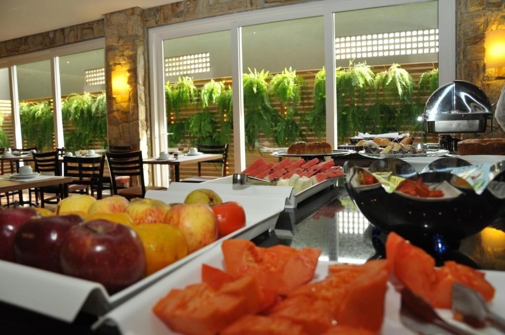 A buffet with fruits, vegetables, and a grill station.