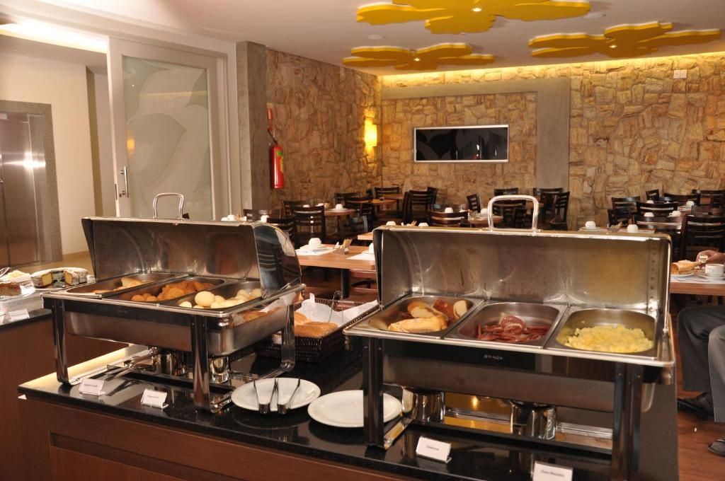 A buffet area with multiple food stations, including a variety of breakfast items.