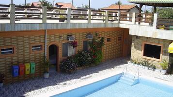 Relax by the pool surrounded by lush gardens and a tranquil seating area.