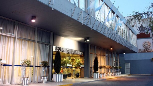 A hotel entrance with a modern design, featuring large windows and a sign that reads "HOTEL 13 DE JULIO". - Intersur Hotel 13 de Julio (Mar del Plata)