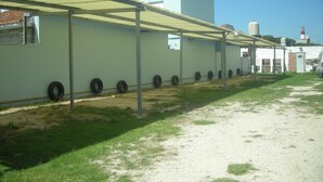 A building with a sign reading "HOTEL" and a row of tires against the wall. - Mar del Faro (Mar del Plata)