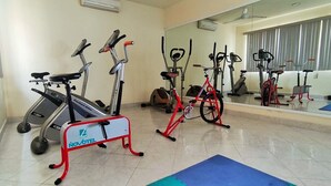 A gym with stationary bikes, a treadmill, and exercise equipment. - Novotel (Poza Rica)