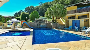 Relax by the pool surrounded by lush greenery and enjoy the tranquil atmosphere.