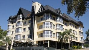 A multi-story hotel with a modern architectural design, featuring balconies, large windows, and a prominent entrance area. - Costarenas Hotel & Spa (Colon)