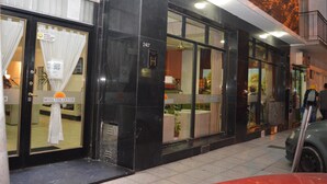 A hotel entrance with a black facade, large windows, and a visible room number 2417. - Hotel Vial Center (Mar del Plata)