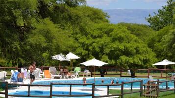 Relax by the pool surrounded by lush greenery and take in the breathtaking mountain views.