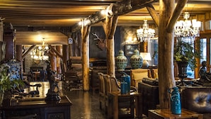 A rustic interior with wooden beams, chandeliers, and antique furniture. - Huilo Huilo Marina del Fuy (Panguipulli)