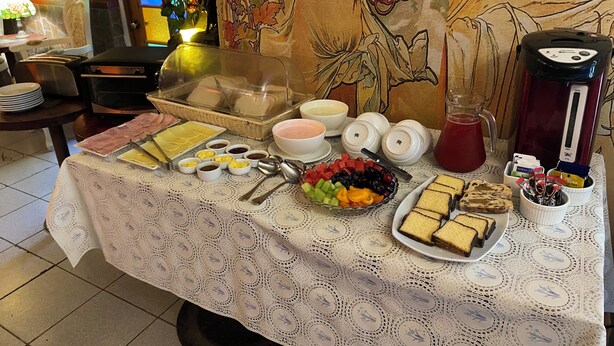A breakfast buffet with various food items, including fruits, pastries, and beverages. - Nubes Hotel (Vina del Mar)