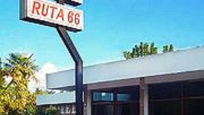A hotel sign indicating 'HOTEL RUTA 66' with a modern building facade and large windows. - Hotel Ruta 66 (Mina Clavero)