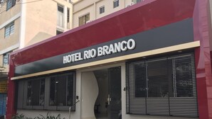 A hotel named HOTEL RIO BRANCO with a modern facade, large windows, and a visible entrance. - Hotel Rio Branco (Goiania)