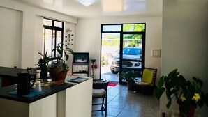 A spacious living area with a large window, a television, and a seating area.